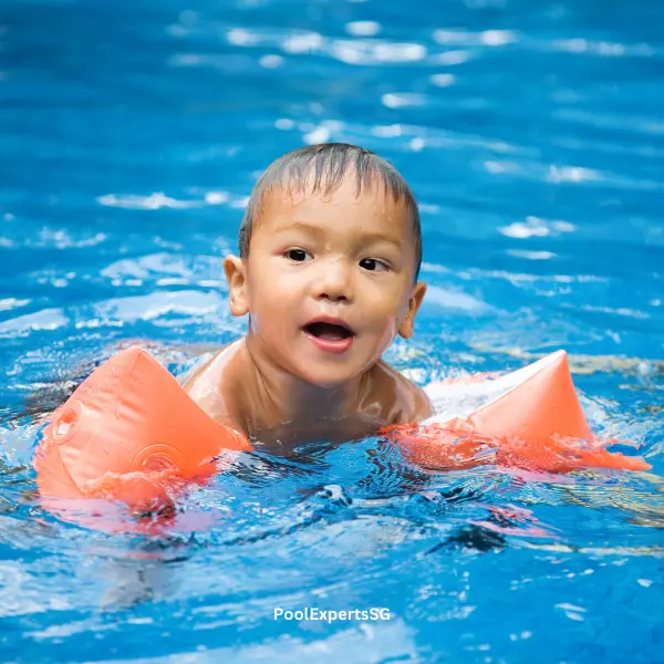 A boy enjoying himself in the swimming pool
